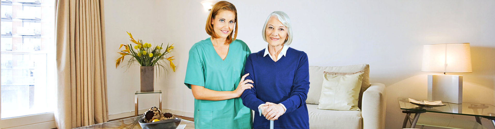 caregiver smiling with elderly woman